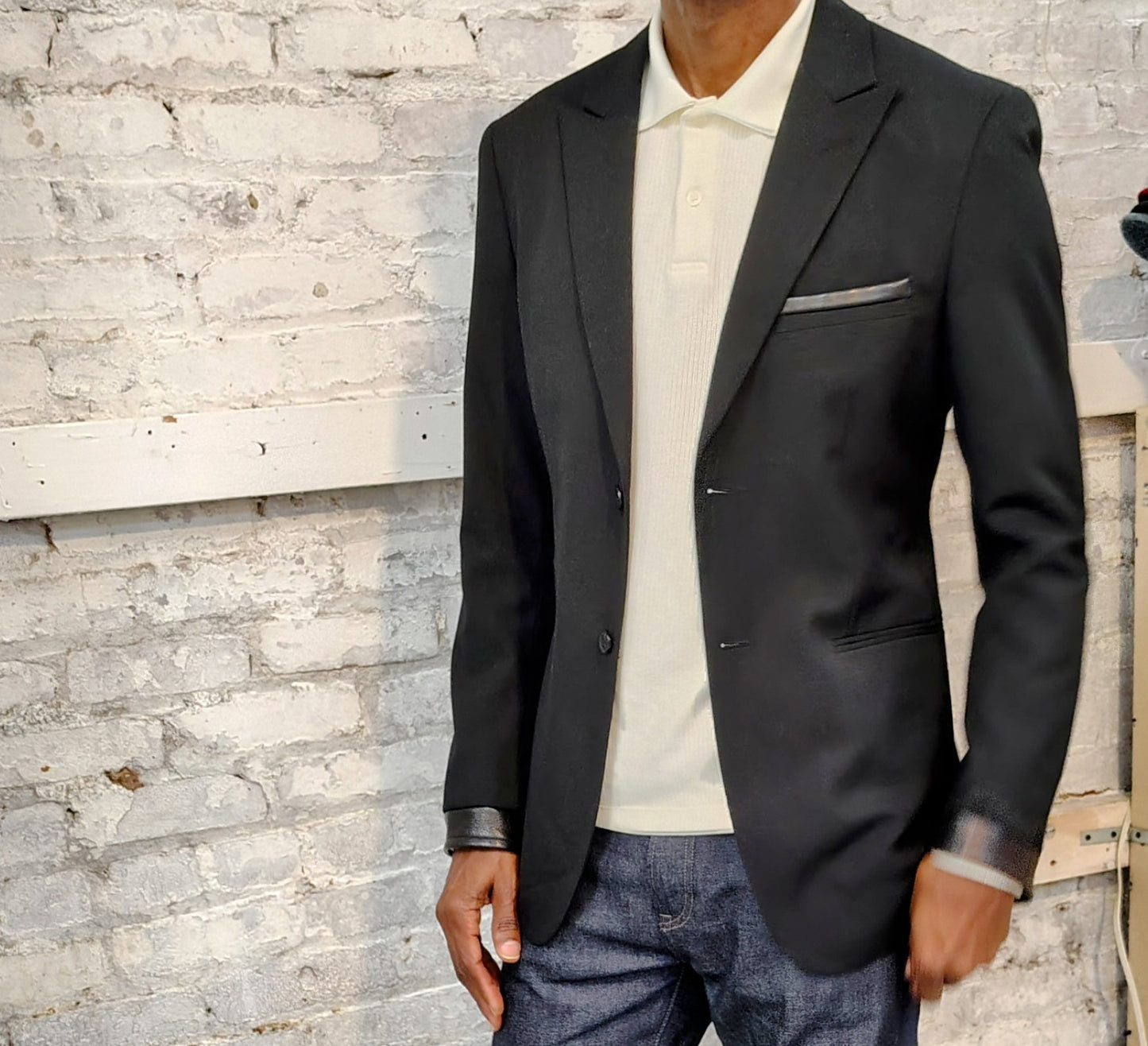 Black blazer with leather cuff in viscose poly/cotton. jacket size 41 long ,leather trimmed breast pocket, up cycled,repurposed, one of a kind. by Wendel Johnston