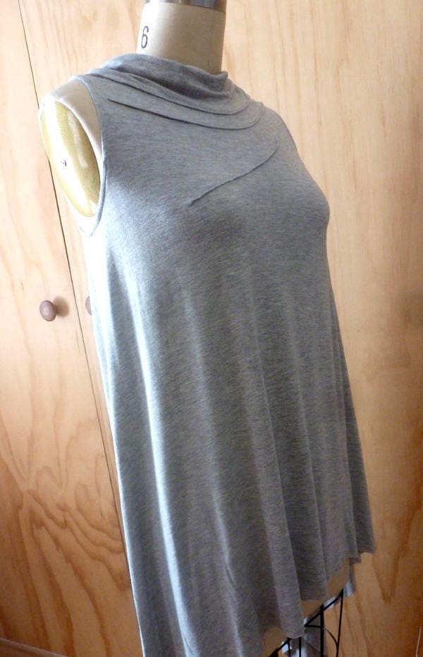 Light gray sleeveless top with front stitch detail and drape back detail