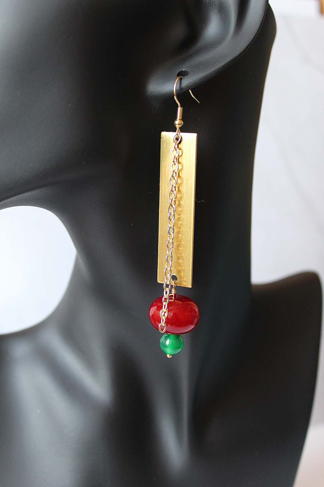 Kwaku - brass sheet with chain and large red & small green bead. Artist Wendel Johnston