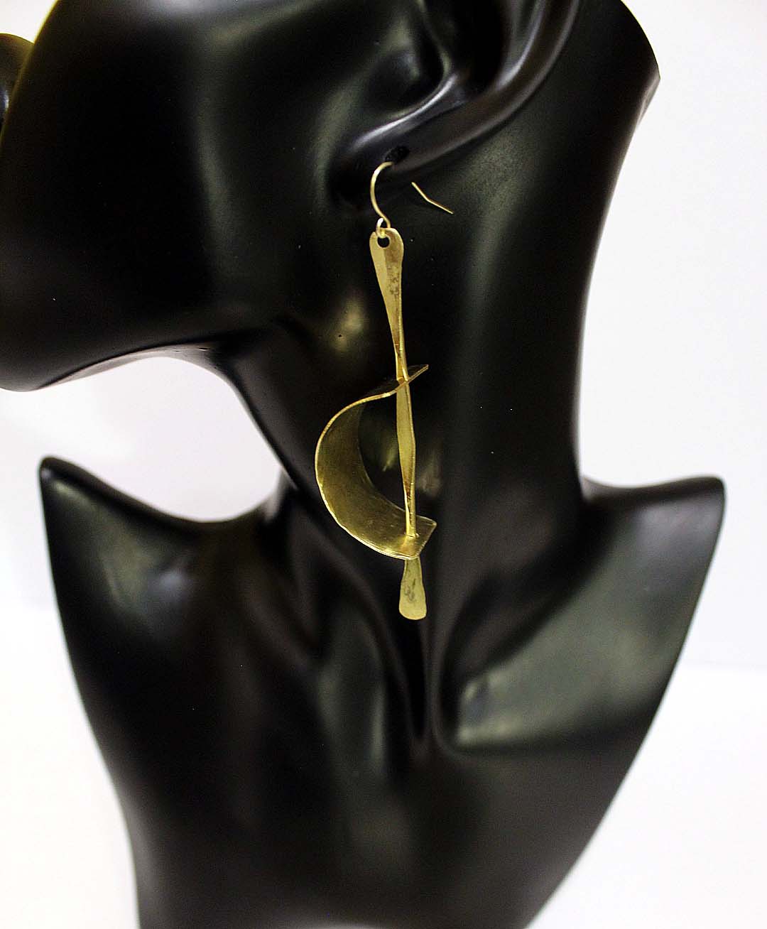 Gede- All brass, curve brass plate with pin through it. Artist Wendel Johnston
