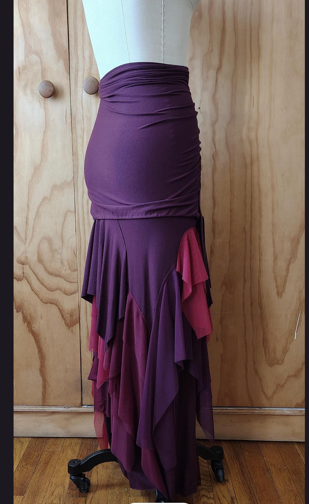 Long plum draped high waisted skirt in rayon Lycra with layers of mesh. Made by Cheryl Johnston for Johnston Designs.