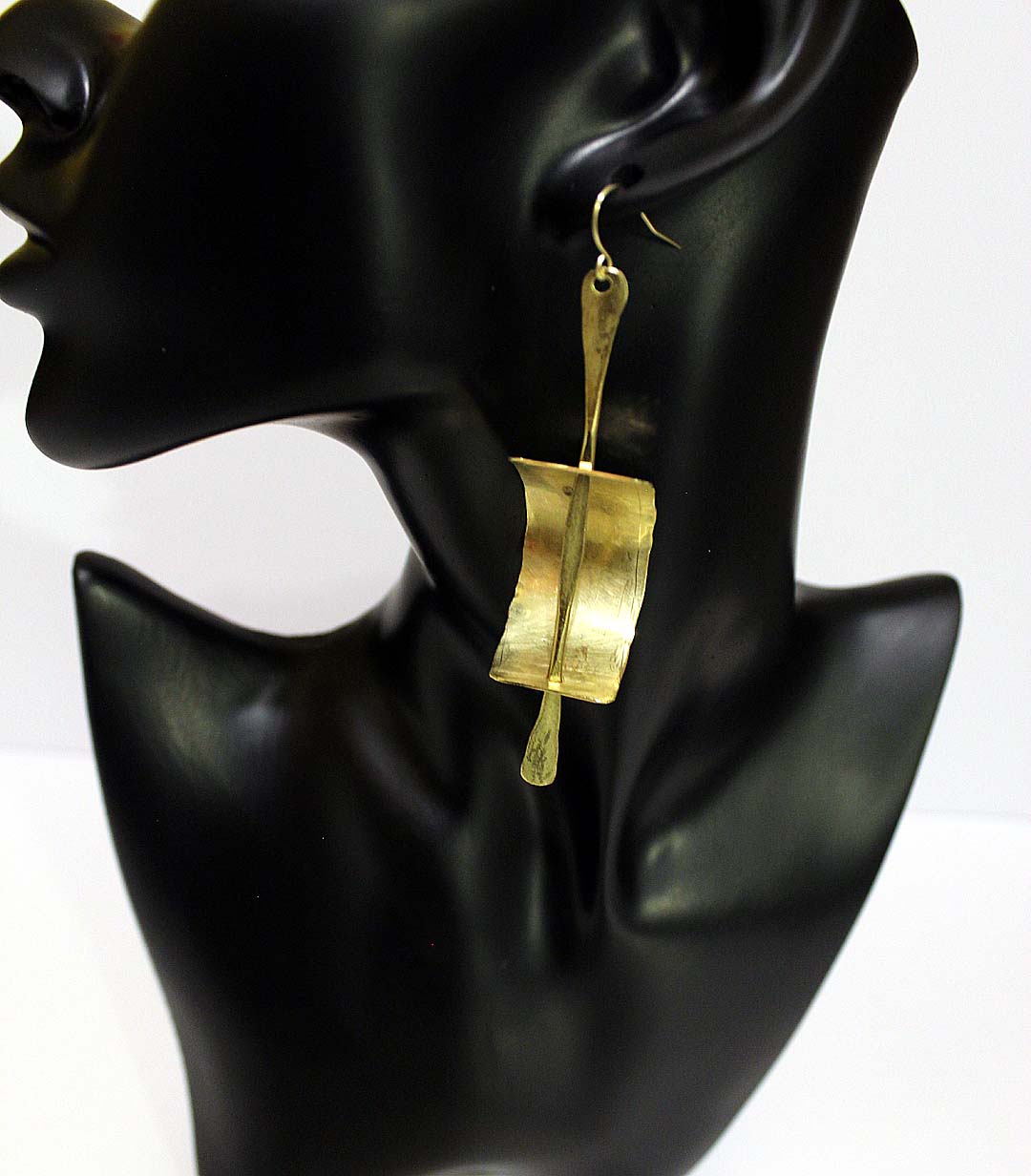 Gede- All brass, curve brass plate with pin through it. Artist Wendel Johnston