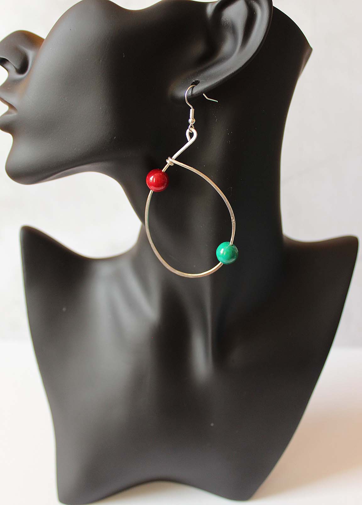 Circ- brass wire with turquoise and red bead. Artist Wendel Johnston