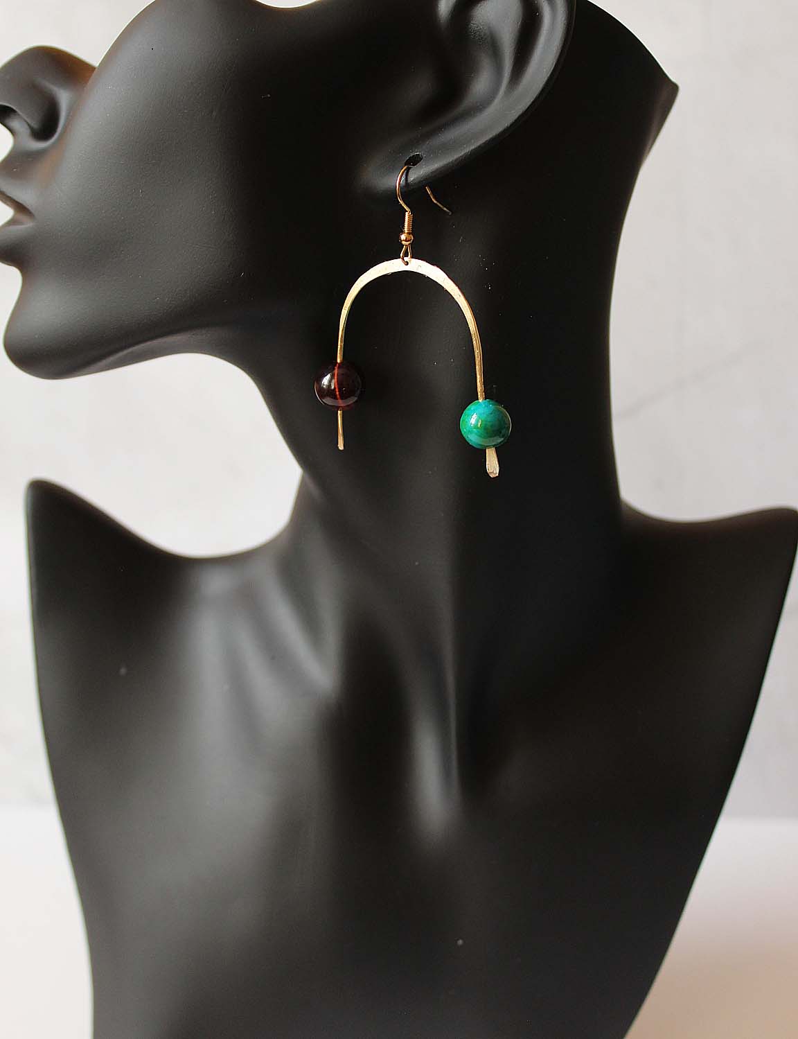 Pippin - horse shoe shaped brass wire with turquoise and brown bead. Artist Wendel Johnston