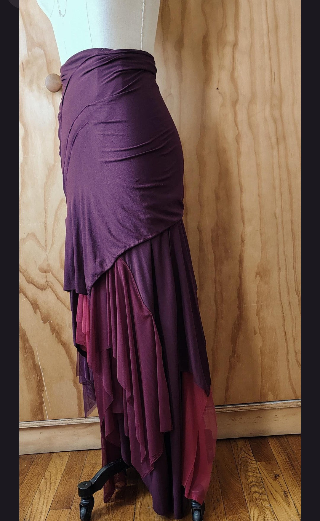 Long plum draped high waisted skirt in rayon Lycra with layers of mesh. Made by Cheryl Johnston for Johnston Designs.