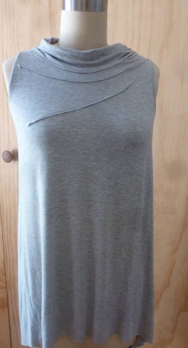 Light gray sleeveless top with front stitch detail and drape back detail