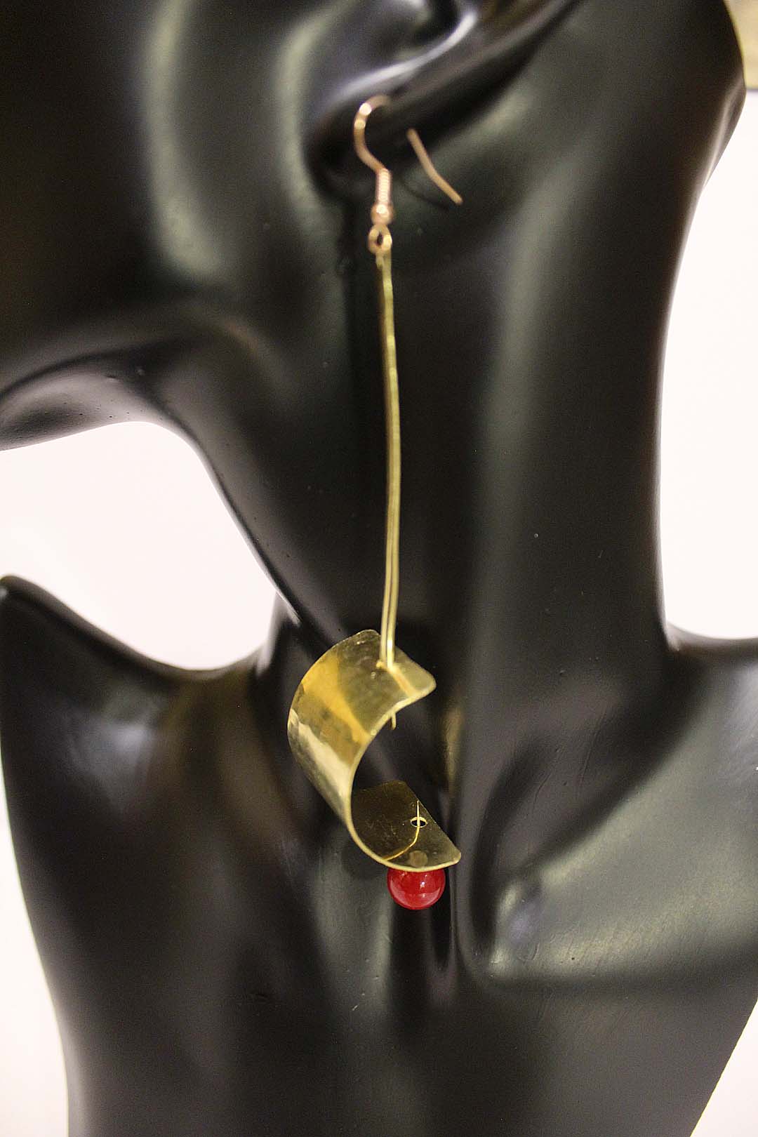 Batwu - Brass curve sheet earrings with pin and red bead. Artist Wendel Johnston